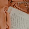 Photo of peach book and glasses by vanessa serpas